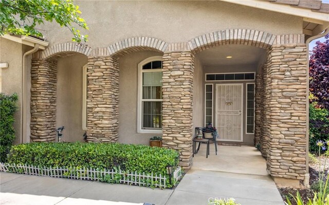 317 Calvert Park, Beaumont, CA 92223 - view of exterior entry featuring stucco siding and stone siding