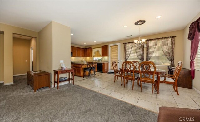 317 Calvert Park, Beaumont, CA 92223 - dining space with a chandelier, recessed lighting, light colored carpet, and light tile patterned floors