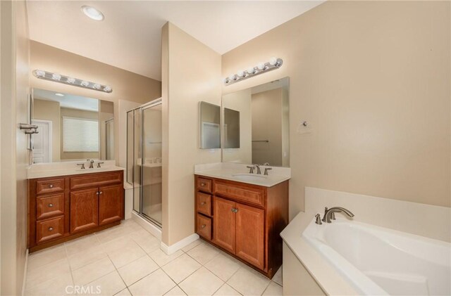 317 Calvert Park, Beaumont, CA 92223 - full bathroom with tile patterned flooring, a stall shower, a garden tub, and two vanities