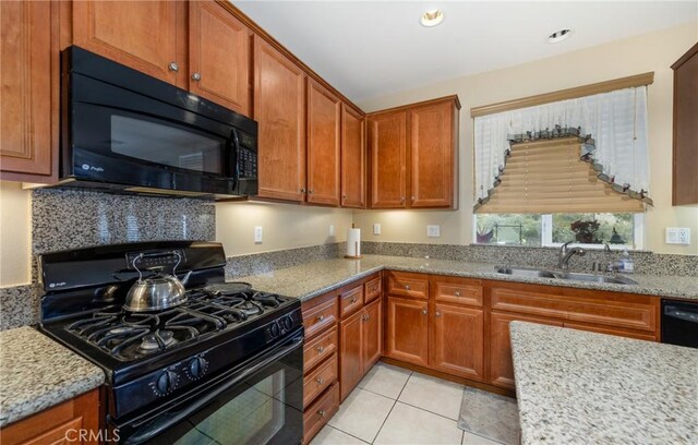 317 Calvert Park, Beaumont, CA 92223 - kitchen featuring black appliances, light stone countertops, brown cabinetry, light tile patterned floors, and recessed lighting