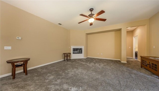 317 Calvert Park, Beaumont, CA 92223 - unfurnished living room featuring ceiling fan, carpet flooring, and a glass covered fireplace