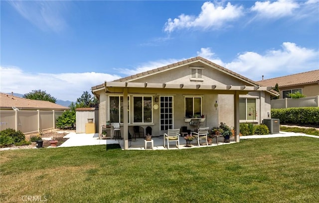 317 Calvert Park, Beaumont, CA 92223 - back of property featuring stucco siding, a fenced backyard, a storage unit, and a patio area