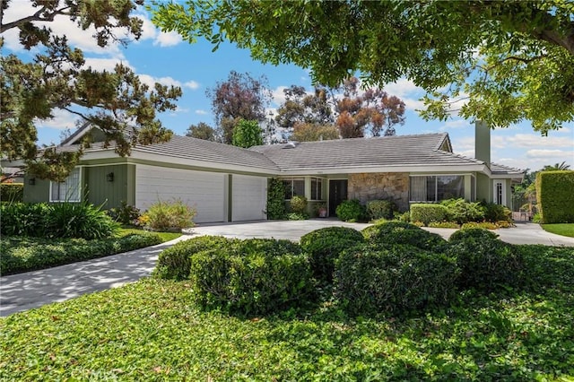 1463 Avolencia Dr, Fullerton, CA 92835 - ranch-style house featuring an attached garage, stone siding, a tiled roof, and driveway