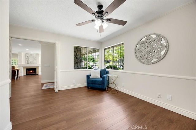1463 Avolencia Dr, Fullerton, CA 92835 - unfurnished room with a ceiling fan, wood finished floors, baseboards, and a warm lit fireplace
