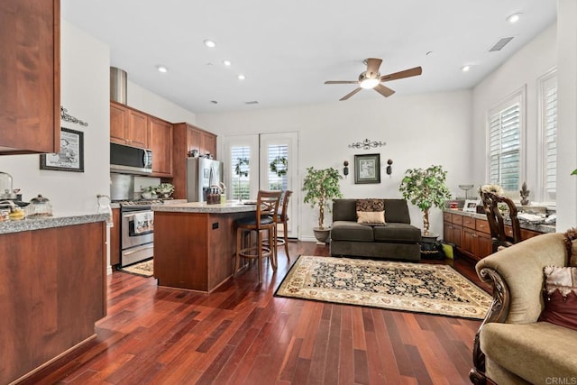 2227 Villa Verde Rd, Escondido, CA 92029 - kitchen featuring appliances with stainless steel finishes, open floor plan, a kitchen breakfast bar, a ceiling fan, and dark wood finished floors