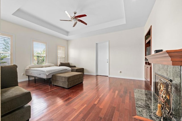 2227 Villa Verde Rd, Escondido, CA 92029 - bedroom with a tray ceiling, wood finished floors, a high end fireplace, and a ceiling fan