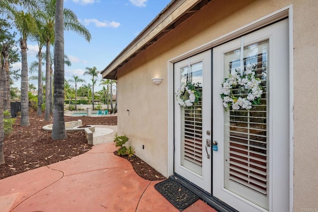 2227 Villa Verde Rd, Escondido, CA 92029 - view of exterior entry with stucco siding, french doors, and an outdoor pool