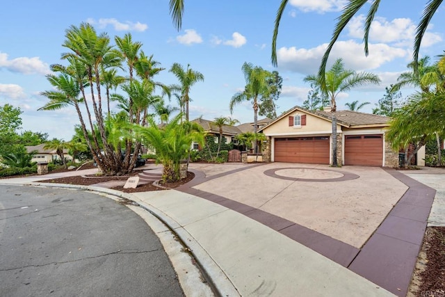 2227 Villa Verde Rd, Escondido, CA 92029 - view of front of home featuring curved driveway, stucco siding, stone siding, and an attached garage