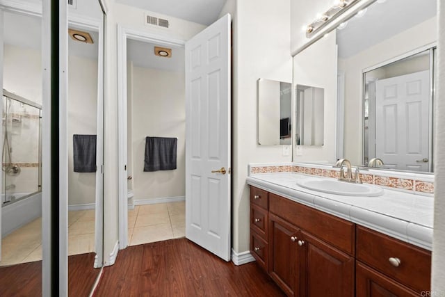 2227 Villa Verde Rd, Escondido, CA 92029 - bathroom with vanity, wood finished floors, and combined bath / shower with glass door