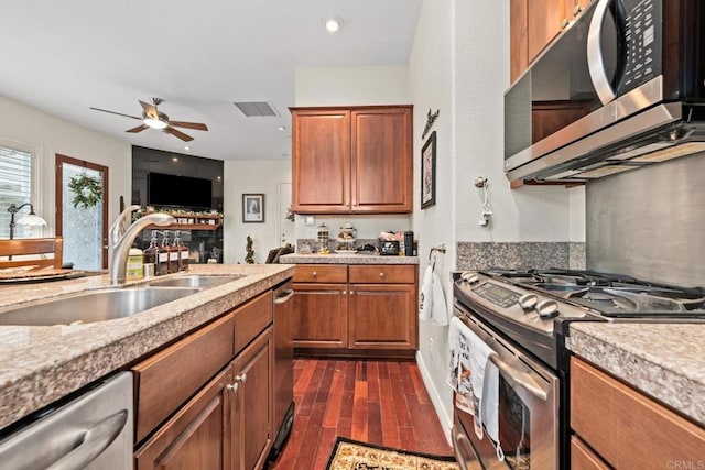 2227 Villa Verde Rd, Escondido, CA 92029 - kitchen featuring appliances with stainless steel finishes, ceiling fan, dark wood finished floors, brown cabinetry, and light countertops