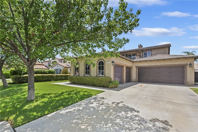 213 Caldera St, Perris, CA 92570 - view of front of home with a garage, stucco siding, driveway, and a front lawn
