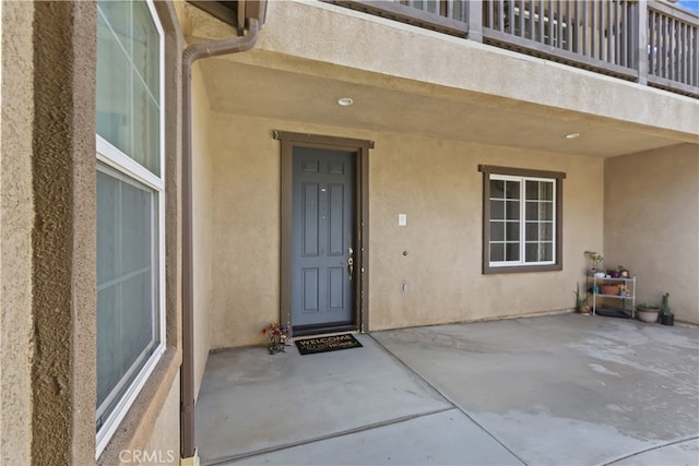 213 Caldera St, Perris, CA 92570 - property entrance featuring stucco siding and a patio