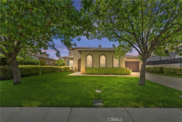 213 Caldera St, Perris, CA 92570 - mediterranean / spanish house featuring stucco siding, driveway, a front yard, and an attached garage