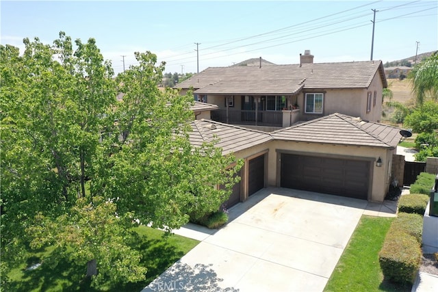 213 Caldera St, Perris, CA 92570 - view of front of home with an attached garage, stucco siding, driveway, a balcony, and a chimney