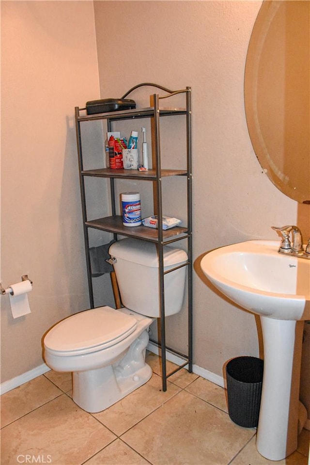 12655 Verano St, Victorville, CA 92392 - half bath featuring toilet, baseboards, and tile patterned floors