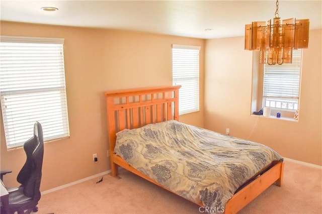 12655 Verano St, Victorville, CA 92392 - carpeted bedroom featuring a chandelier and baseboards