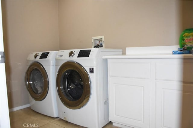 12655 Verano St, Victorville, CA 92392 - washroom featuring washing machine and clothes dryer, cabinet space, and light tile patterned floors