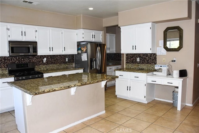 12655 Verano St, Victorville, CA 92392 - kitchen featuring stainless steel appliances, dark stone counters, light tile patterned flooring, decorative backsplash, and recessed lighting