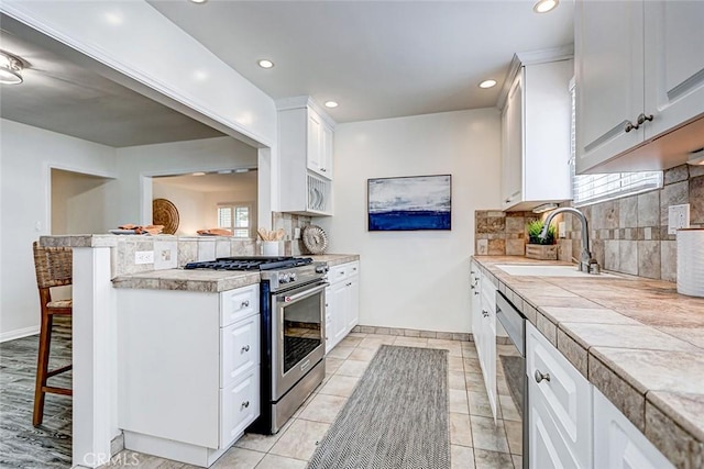 1217 S Gertruda Ave, Redondo Beach, CA 90277 - kitchen with appliances with stainless steel finishes, a sink, a kitchen bar, backsplash, and recessed lighting