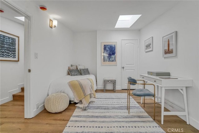 232 Howland Canal, Venice, CA 90291 - bedroom featuring a skylight, wood finished floors, and baseboards