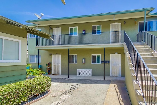 420921 3rd Ave, San Diego, CA 92103 - rear view of property featuring stairs, stucco siding, and a patio area