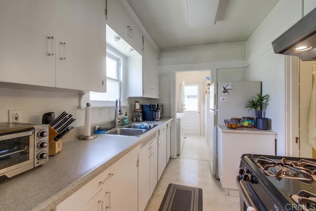 420921 3rd Ave, San Diego, CA 92103 - kitchen with a sink, healthy amount of natural light, white cabinetry, and range with gas stovetop
