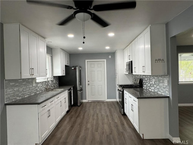 1227 N Fairvalley Ave, Covina, CA 91722 - kitchen with stainless steel appliances, a sink, baseboards, dark countertops, and recessed lighting