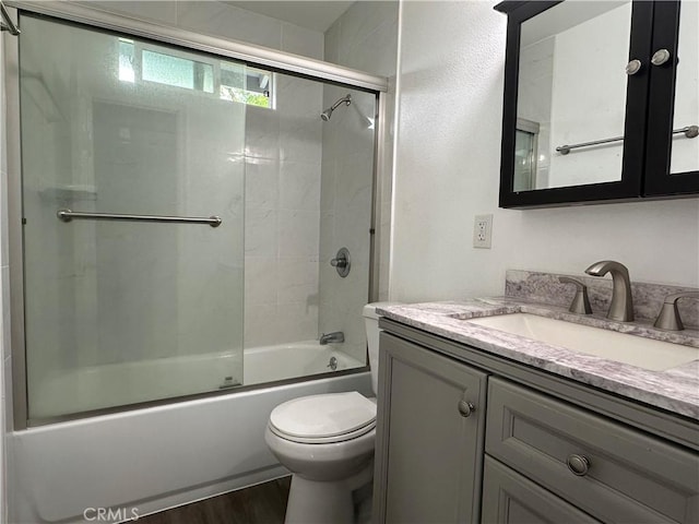 1227 N Fairvalley Ave, Covina, CA 91722 - full bath featuring vanity, toilet, combined bath / shower with glass door, and wood finished floors
