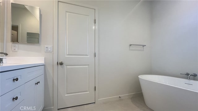 110 Sunnyside, Irvine, CA 92618 - bathroom featuring a freestanding bath, vanity, and baseboards
