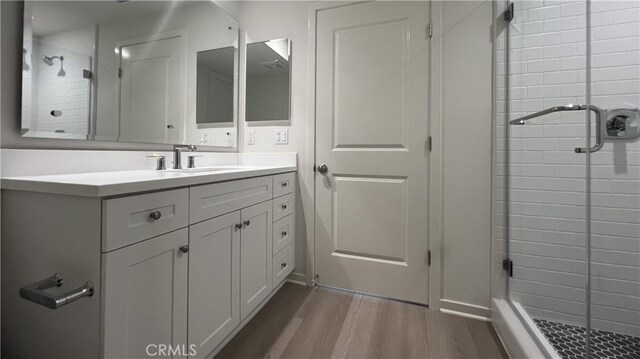 110 Sunnyside, Irvine, CA 92618 - bathroom featuring a shower stall, vanity, and wood finished floors
