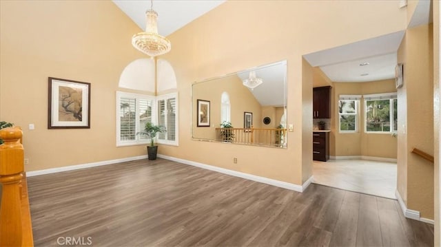 2210 Olympic View Dr, Chino Hills, CA 91709 - unfurnished dining area featuring wood finished floors, baseboards, and high vaulted ceiling