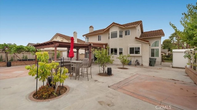 2210 Olympic View Dr, Chino Hills, CA 91709 - back of property featuring a tile roof, a patio area, a fenced backyard, a chimney, and outdoor dining area