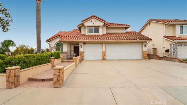 2210 Olympic View Dr, Chino Hills, CA 91709 - mediterranean / spanish-style house with stucco siding, driveway, a tile roof, and an attached garage