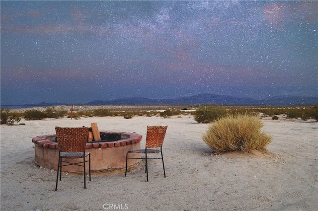 310 Enchanted Rd, Joshua Tree, CA 92252 - water view featuring a fire pit and mountains