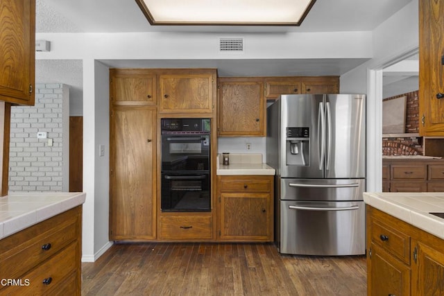 6421 Almar St, Simi Valley, CA 93063 - kitchen featuring stainless steel fridge with ice dispenser, tile counters, brown cabinets, and dark wood-style flooring