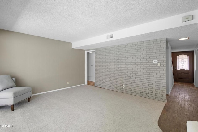 6421 Almar St, Simi Valley, CA 93063 - unfurnished room featuring a textured ceiling, brick wall, and wood finished floors