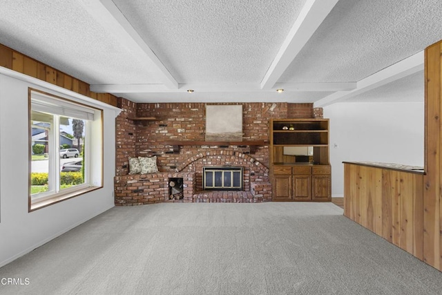 6421 Almar St, Simi Valley, CA 93063 - unfurnished living room with a textured ceiling, carpet flooring, beamed ceiling, a brick fireplace, and wood walls