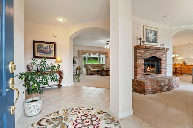 23406 Oakely Pl, Ramona, CA 92065 - carpeted foyer featuring arched walkways, a ceiling fan, a brick fireplace, baseboards, and tile patterned flooring