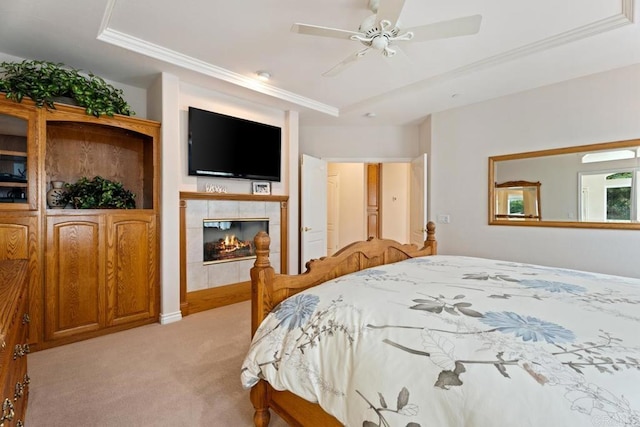 23406 Oakely Pl, Ramona, CA 92065 - bedroom featuring light colored carpet, a tray ceiling, crown molding, a fireplace, and a ceiling fan