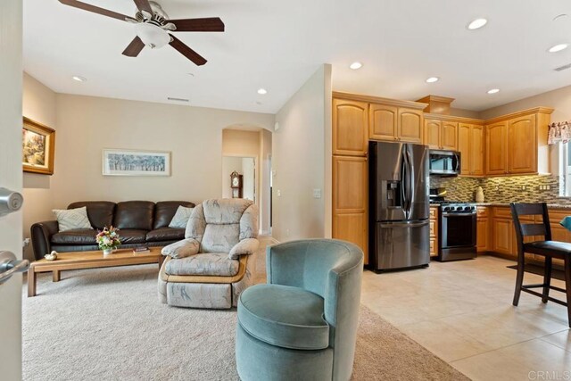 23406 Oakely Pl, Ramona, CA 92065 - living room featuring arched walkways, ceiling fan, recessed lighting, light tile patterned floors, and light colored carpet