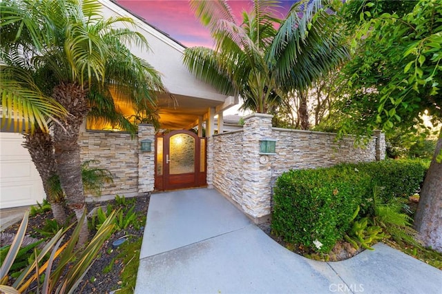 3 Harbor Ridge Dr, Newport Beach, CA 92660 - exterior entry at dusk featuring stone siding