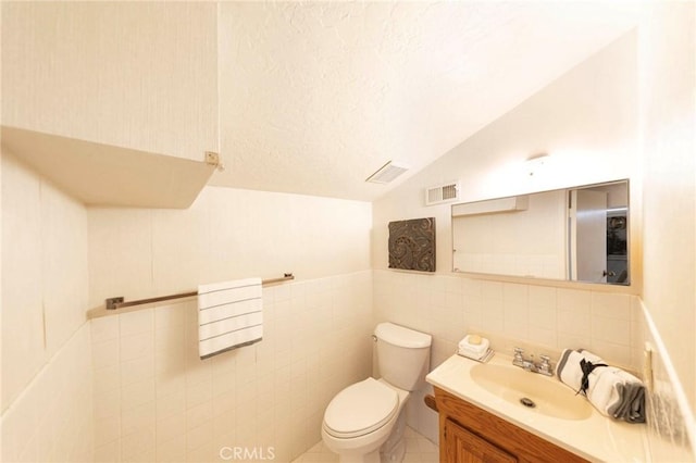 3 Harbor Ridge Dr, Newport Beach, CA 92660 - half bathroom with vaulted ceiling, vanity, tile walls, and a textured ceiling