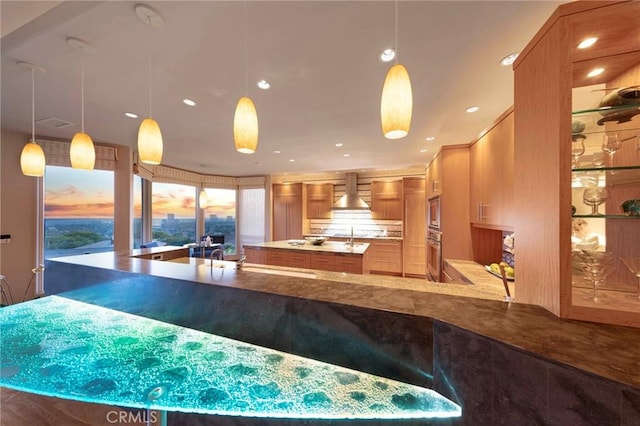 3 Harbor Ridge Dr, Newport Beach, CA 92660 - kitchen with stainless steel appliances, an island with sink, wall chimney exhaust hood, brown cabinets, and recessed lighting