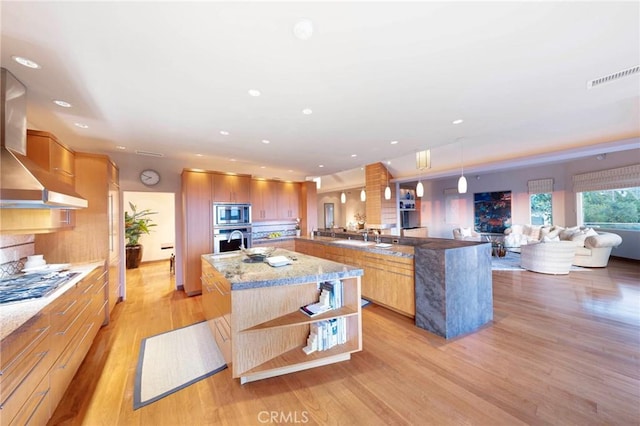 3 Harbor Ridge Dr, Newport Beach, CA 92660 - kitchen with stainless steel appliances, wall chimney range hood, a large island with sink, light wood finished floors, and open shelves