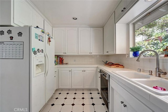 2917 Highridge Rd, La Crescenta, CA 91214 - kitchen featuring white refrigerator with ice dispenser, a sink, plenty of natural light, white cabinetry, and recessed lighting