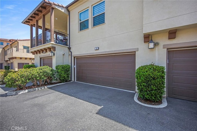 228 Borrego, Irvine, CA 92618 - view of front facade with a garage, a balcony, and stucco siding