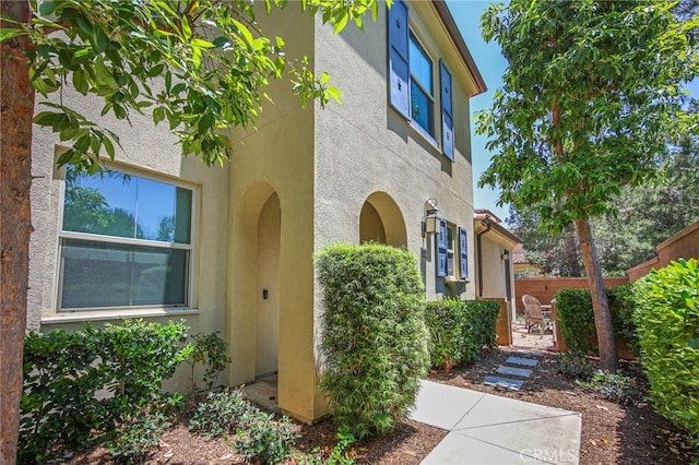 228 Borrego, Irvine, CA 92618 - view of side of property with stucco siding and a patio area