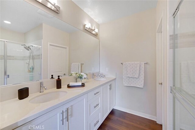 228 Borrego, Irvine, CA 92618 - full bathroom with double vanity, a stall shower, and wood finished floors