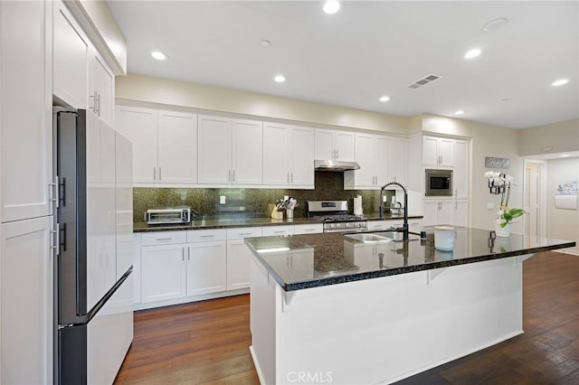 228 Borrego, Irvine, CA 92618 - kitchen with stainless steel appliances, under cabinet range hood, dark wood-type flooring, white cabinets, and recessed lighting