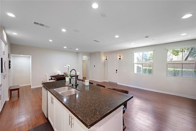 228 Borrego, Irvine, CA 92618 - kitchen with stainless steel dishwasher, dark wood-style flooring, recessed lighting, an island with sink, and white cabinetry